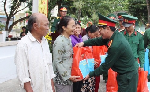 Đại tá Trần Thân trao quà cho các gia đình nghèo.